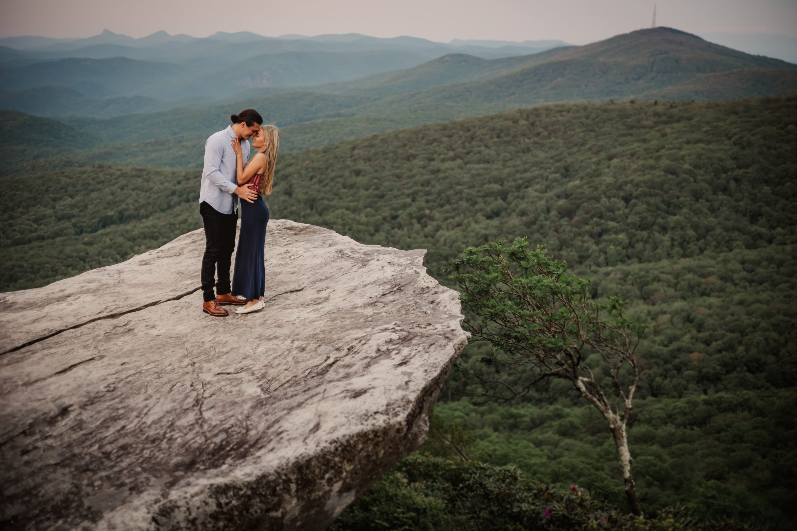 A couple embracing at sunrise in the mountains